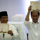 Indonesian president Joko Widodo, right, and his opponent, Prabowo Subianto, held up their ballot numbers at the election commission’s headquarters in September.